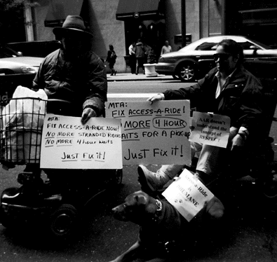 Demonstrators holding signs reading Just Fix It!