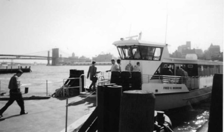 photo of a man walking up two steps into a ferry