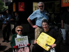 Picture of people in wheelchairs holding signs