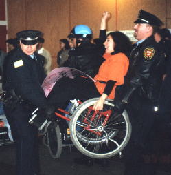 Nadina LaSpina being carried away by police